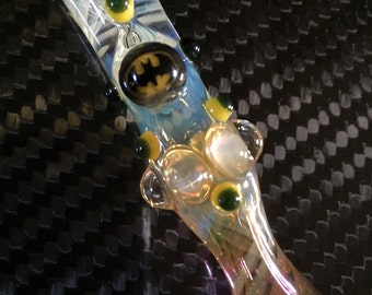 BATMAN Glass pipe is a fumed one hitter. Hand blown BATMAN Millie with highlights. Color changing. Flat mouth piece.