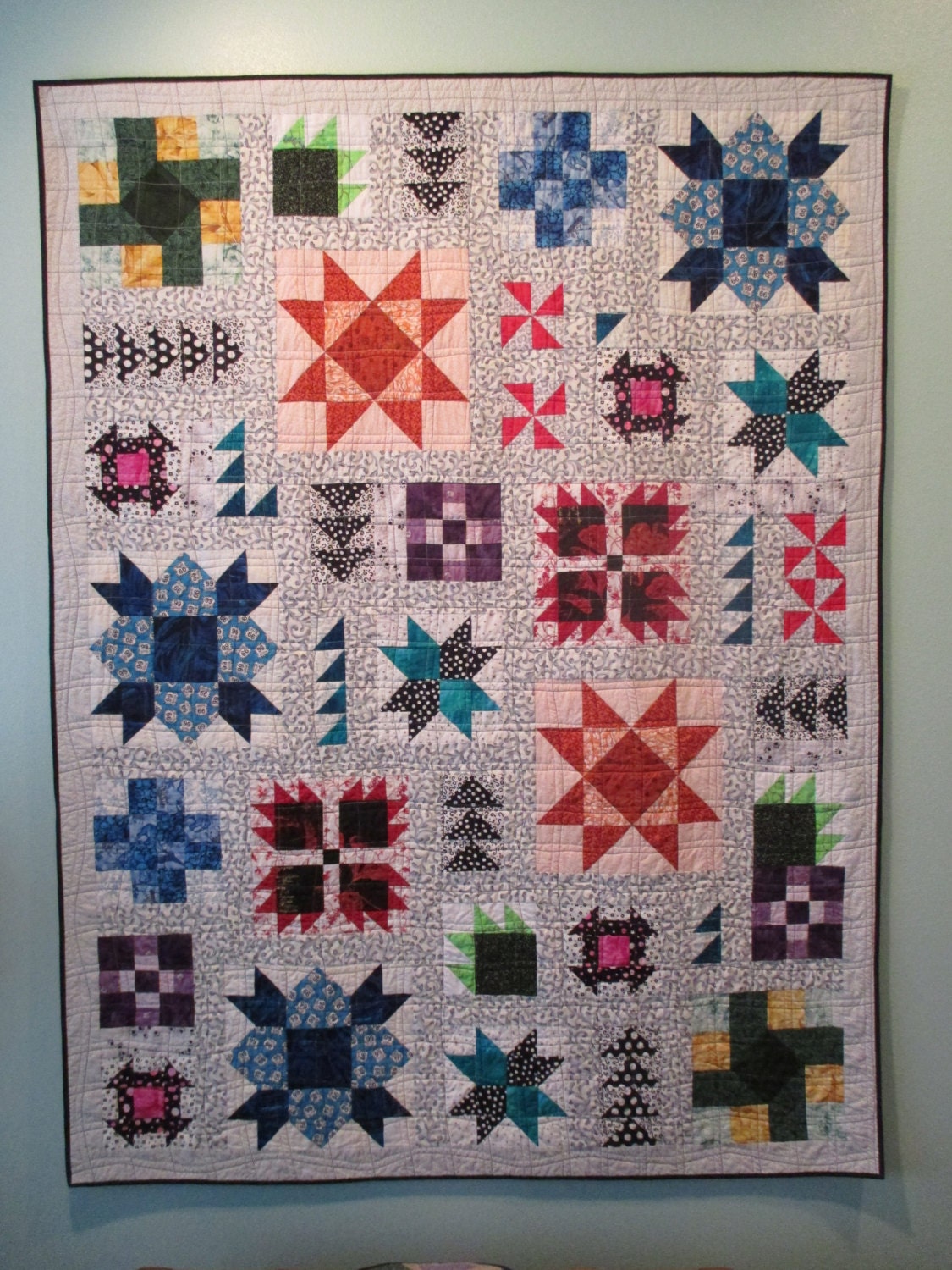 Bright colored sampler lap quilt with white by bunchberrystudio