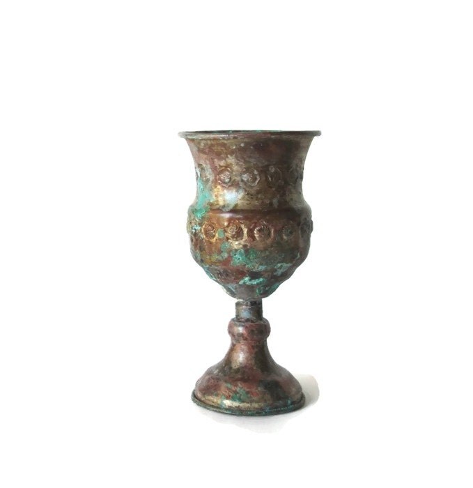 Old copper wine goblet. Metal wine glass. Embossed copper wine