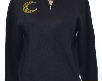Black merino wool sweater with front zippered collar embroidered with swirly moon design