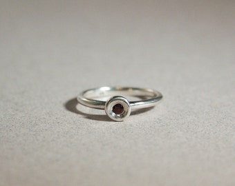 silver organic pod ring with garnet gemstone