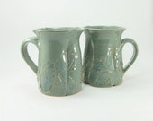 pair of leafy green mugs
