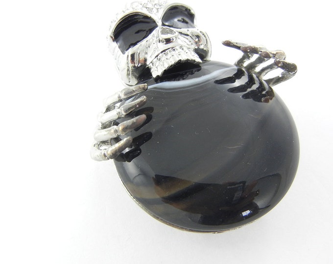 Silver-tone Dimensional Skull Holding Acrylic Black Marble Disk Pendant