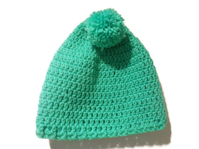 green pom pom hat