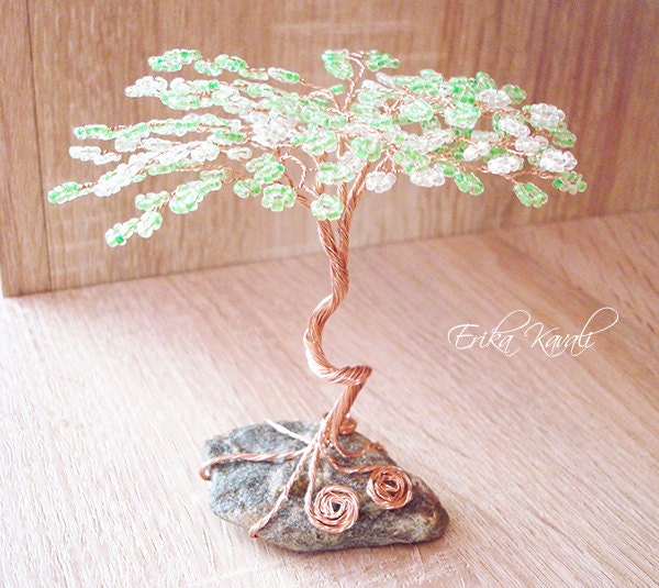 Beaded wire tree sculpture with green seed beads standing on