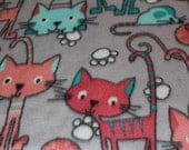 Handmade, soft, padded, fleece cat mat (with an opening for cat nip) featuring pink, peach and blue cats on a gray background Handmade, soft, padded, fleece cat mat (with an opening for cat nip) featuring pink, peach and blue cats on a gray background