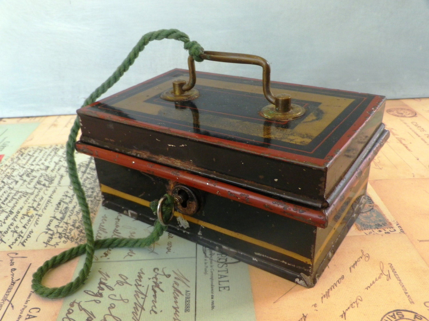 A 1930s locking tinplate cash box or money box with hinged lid and key. Cash box , cash tin