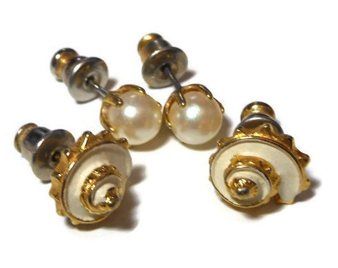 Two pair stud earrings, faux pearl in gold tone setting and gold with white enamel shell post earrings