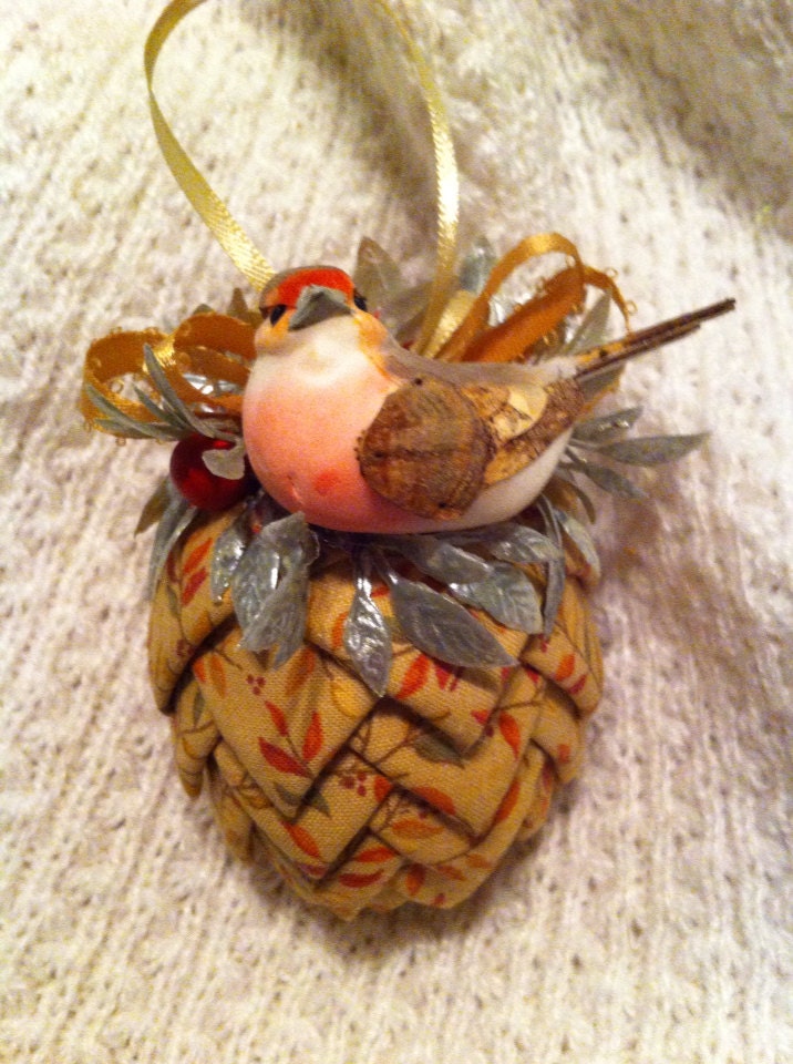 Tan leaf print fabric pinecone decoration.