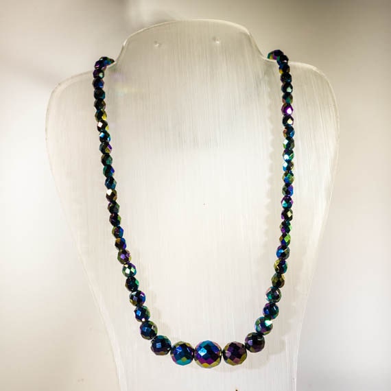 Beaded necklace in faceted carnival glass; dark beads on medium string
