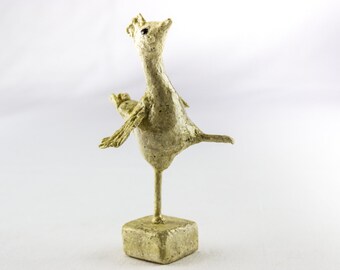 Elfie is a little, happy chicken sculpture.