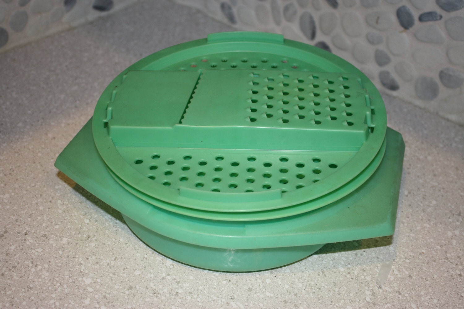 Green tupperware cheese grater and storage by berendsgarage