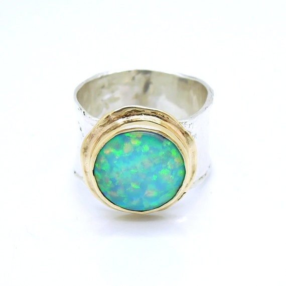Man opal ring in gold and a silver curvy wide band