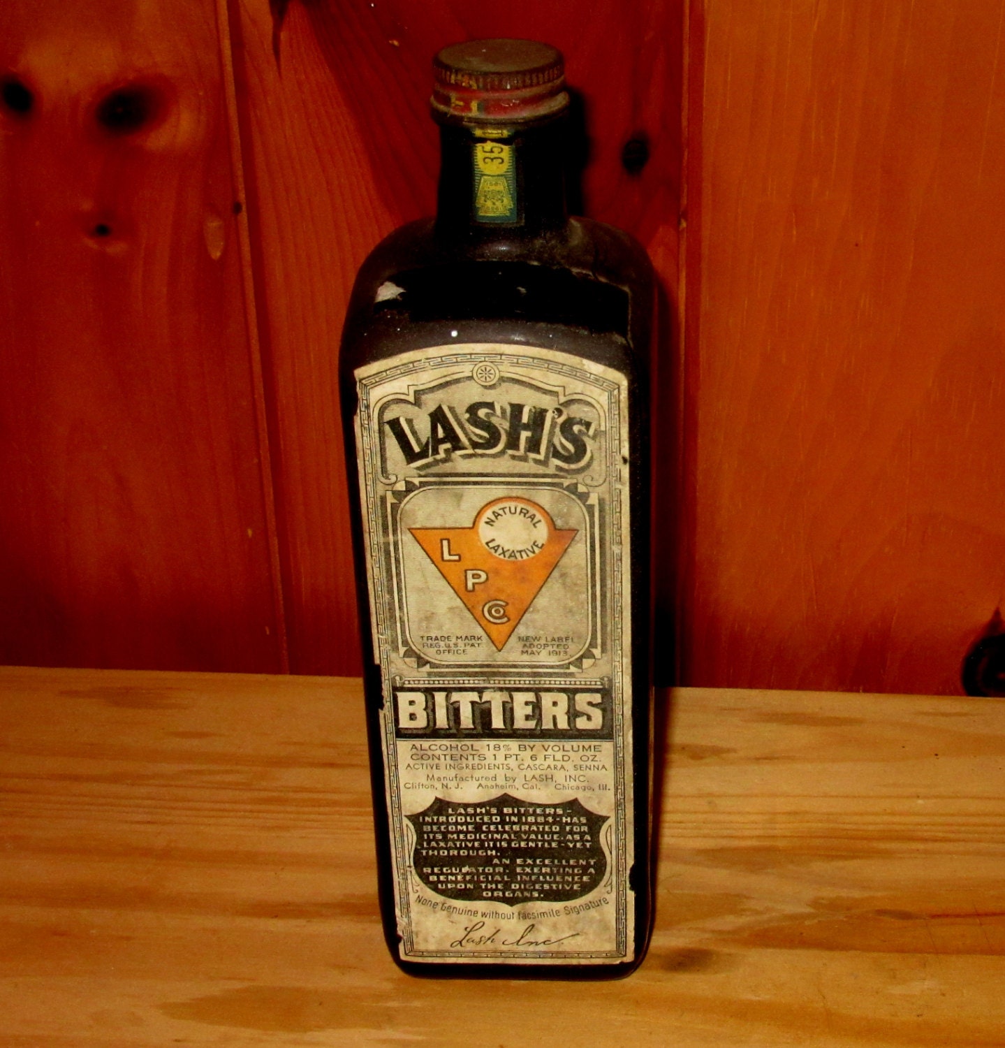 lashs bitters bottle full contents with 1913 label and metal