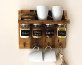 Gorgeous spices or coffee shelf with hanging jars which have chalkboard labels and hooks to hang towels, cups etc.