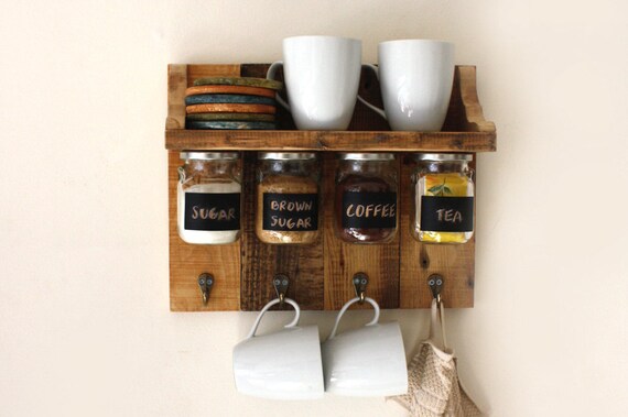 Gorgeous spices or coffee shelf with hanging jars which have chalkboard labels and hooks to hang towels, cups etc.