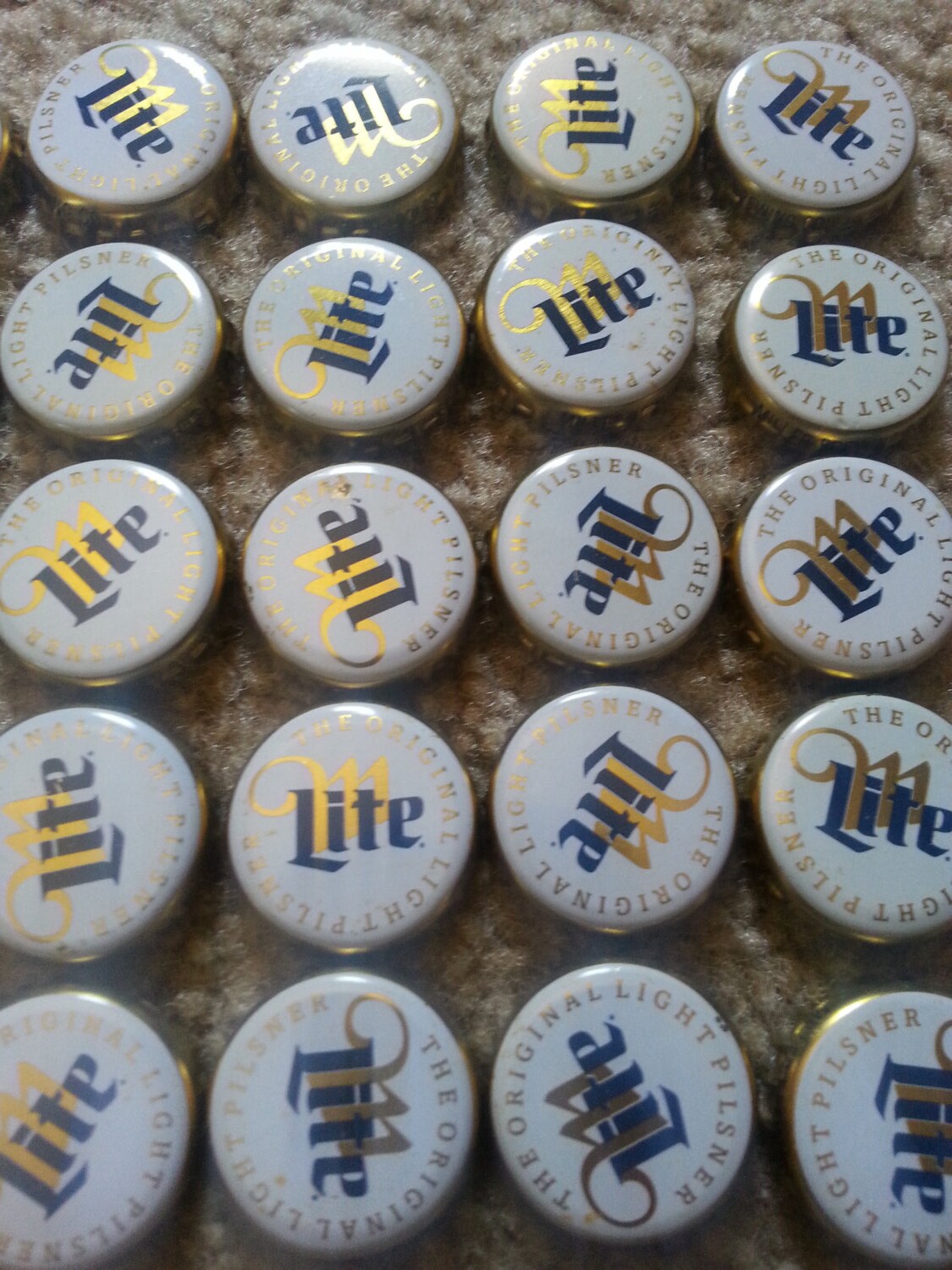 100 dented Miller Light bottle caps