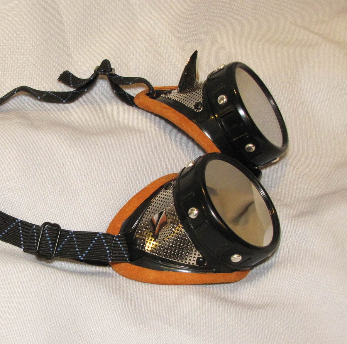 Mad Max style dust goggles with mirror lenses.