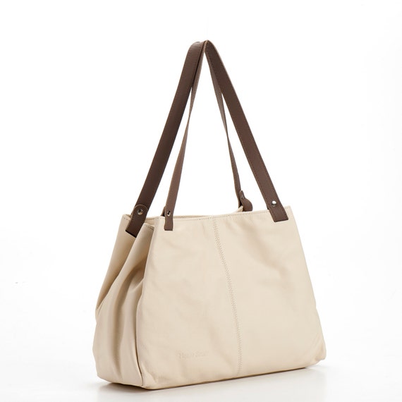 cream over shoulder bag