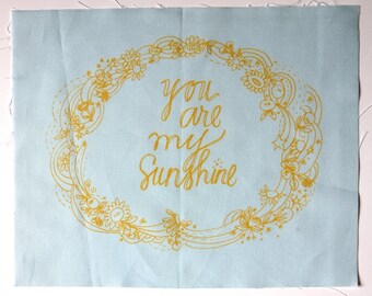 embroidery pattern on fabric You Are My Sunshine yellow on blue