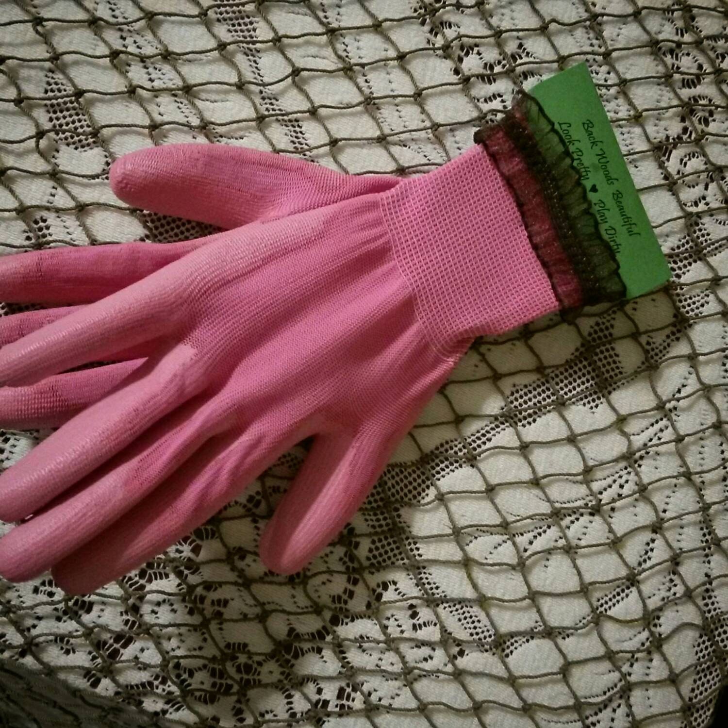 Pink women's fishing gloves with brown ruffled trim