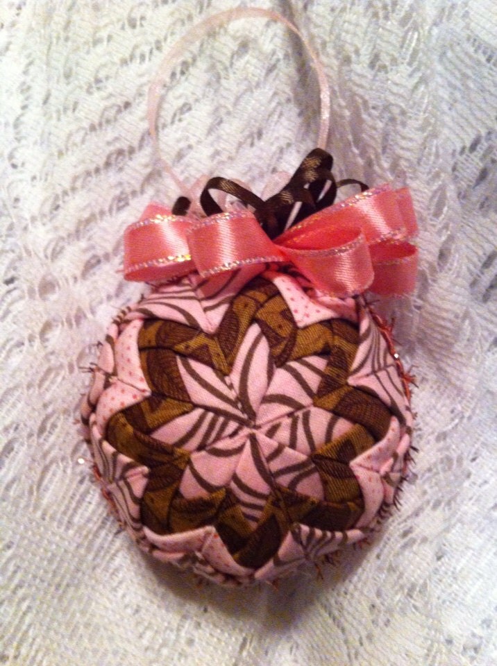 Pink and brown folded star ball ornament. 