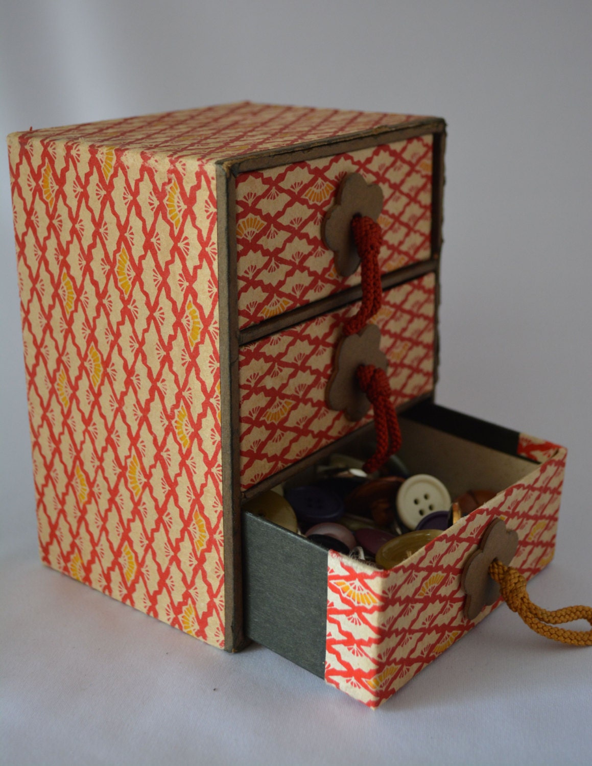 Paper covered box with three small drawers and buttonsvintage