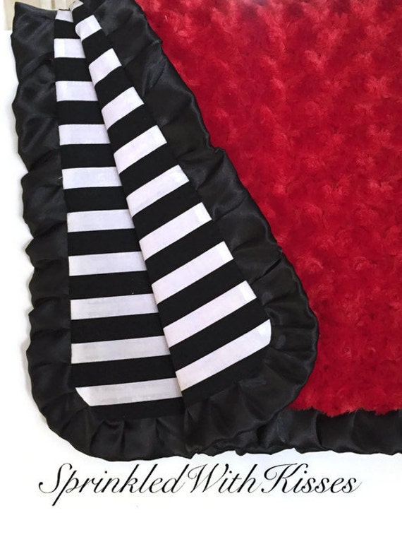 Red minky baby blanket with black satin and black and white