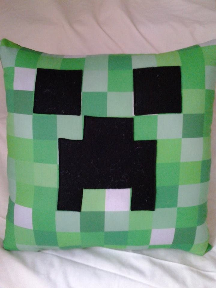 Minecraft Creeper pillow on pixelated fabric