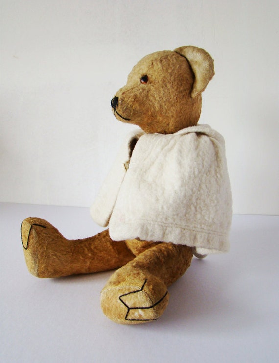 old teddy bear stuffed with straw