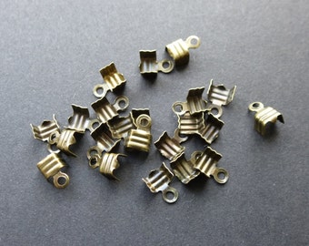 Fold over end caps with loop for cord necklace, bronze tone. Diameter 7mm x 5mm set of 100