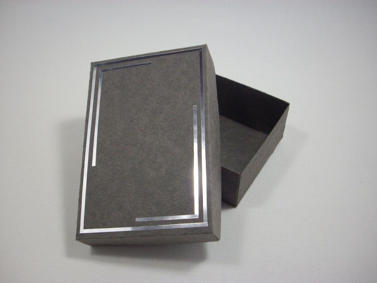 Grey cardboard gift box with shiny silver edges by SpecialGlam