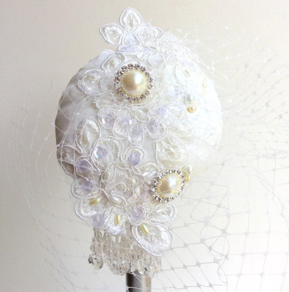 Ivory Bridal cocktail hat with birdcage veil, beading and embroidery.