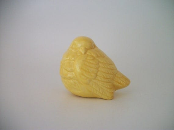 yellow ceramic bird figurine