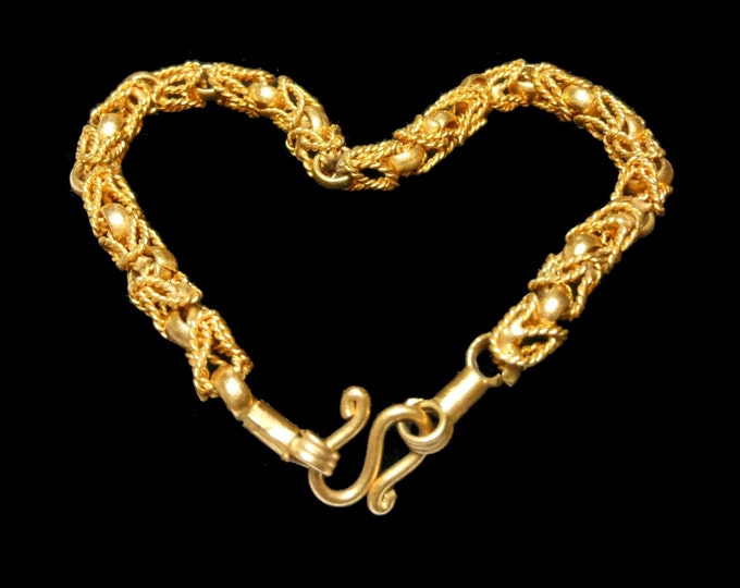 Gold link bracelet, gold links combine with twisted rope links for an intricate look