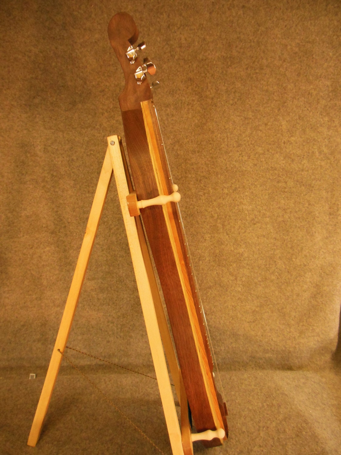 Mountain Dulcimer which is hour glass shape made from Walnut