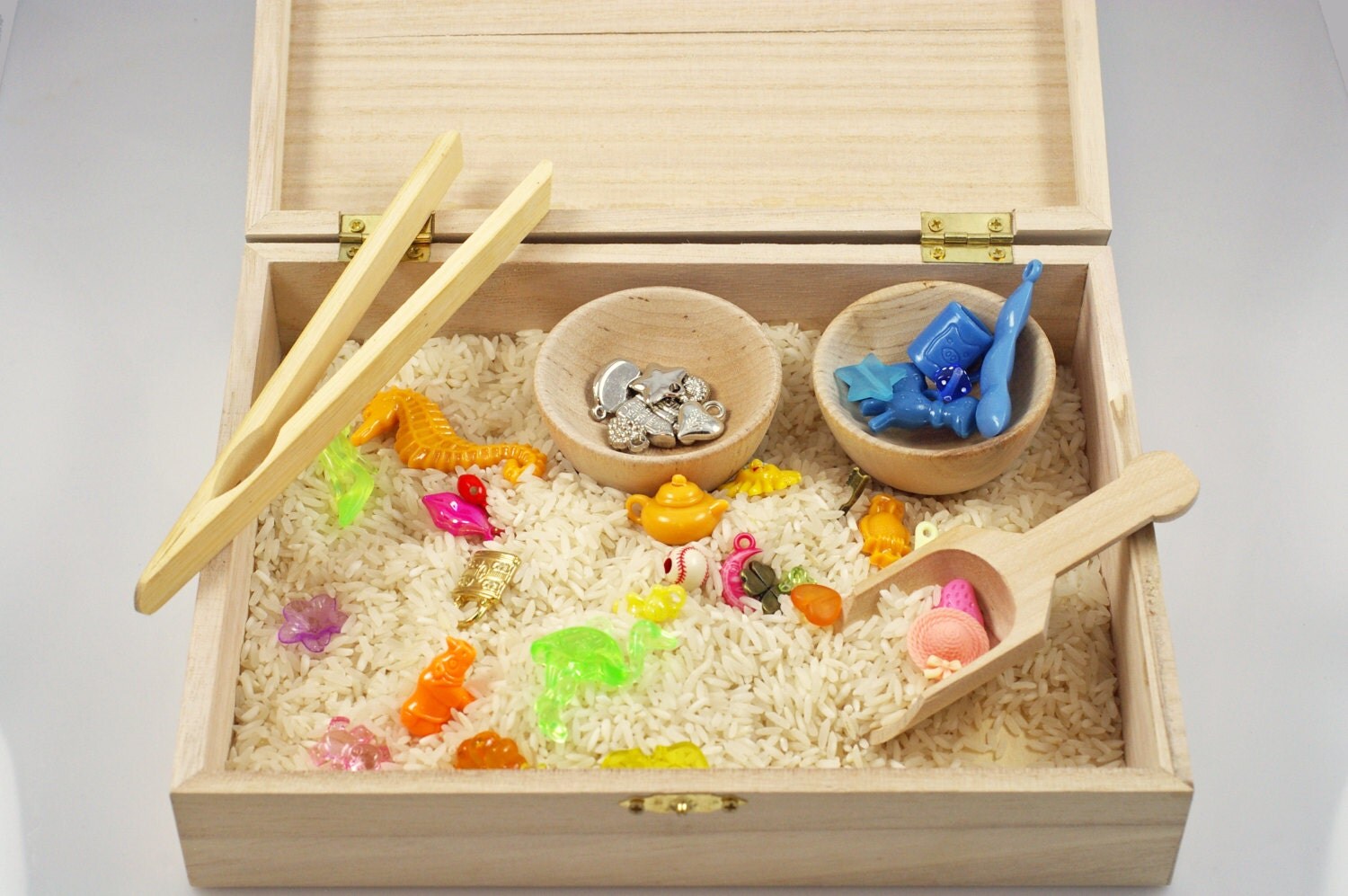 Wooden sensory box of trinkets sensory materials Montessori