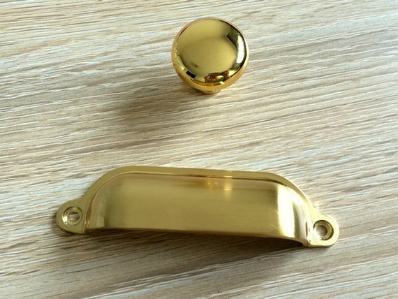 Handles gold dresser near