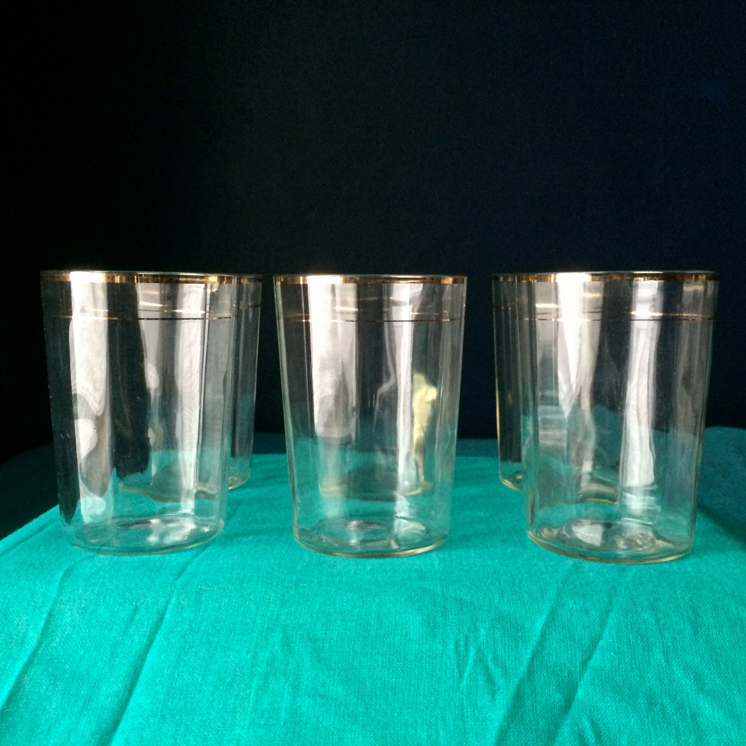 Set of five vintage gold rimmed tumblers.