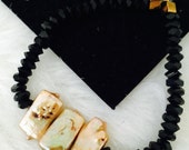 Black beaded bracelet with gold pearls