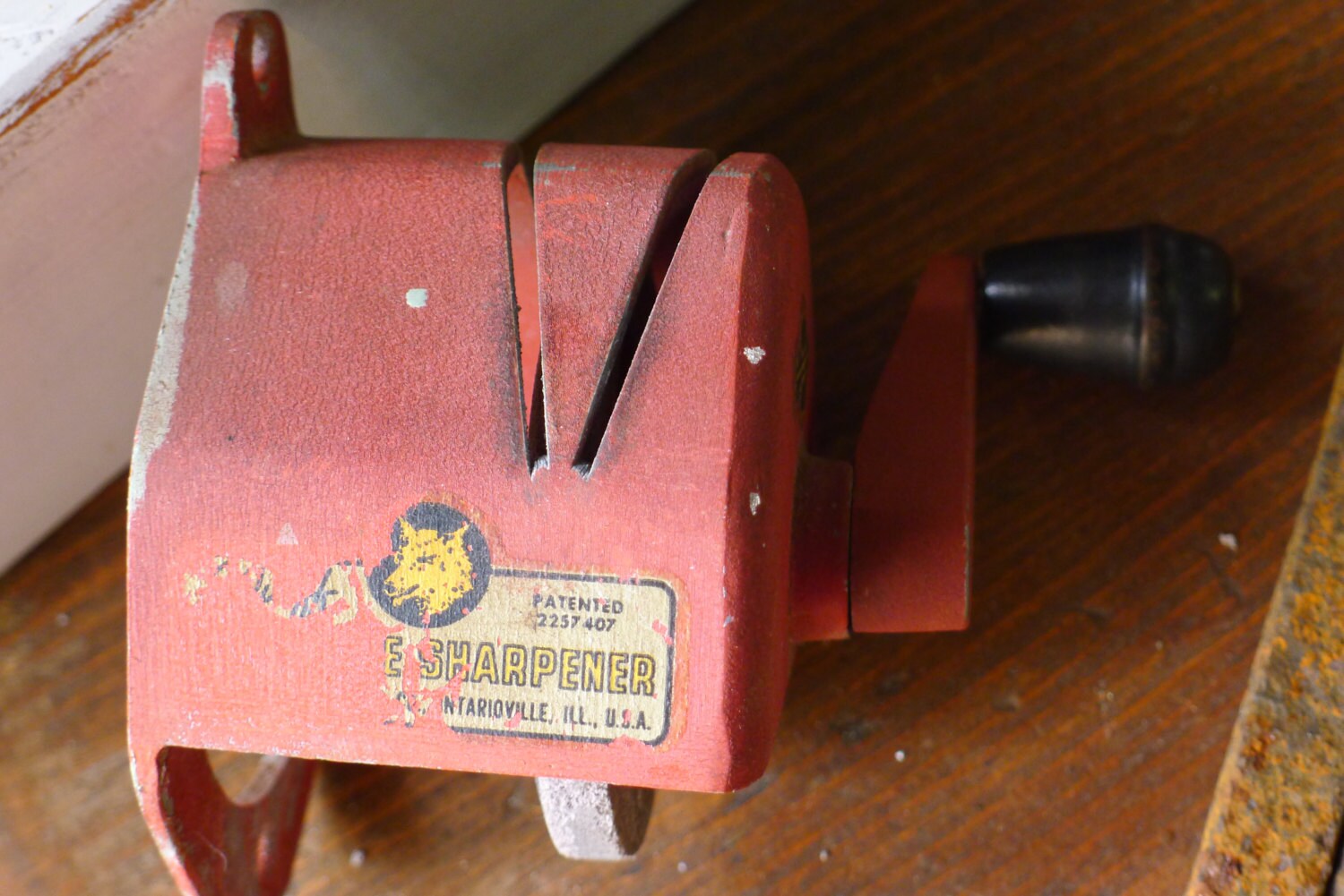 Wall mounted knife sharpener with grinding stone