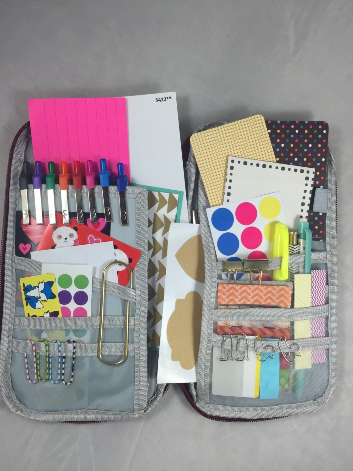 Red zipper planner kit with planner accessories and pens for