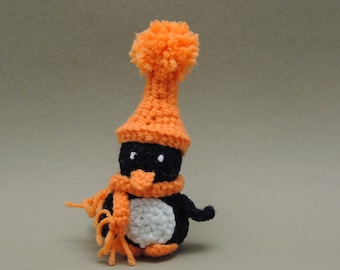 Crochet Amigurumi Penguin in an Orange hat and scarf