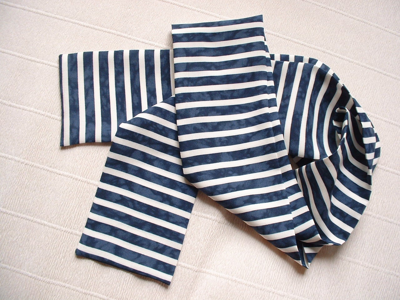 Blue and white striped scarf This classic stripe-print scarf is made from a gauzy lightweight fabric so you can wear it anytime, anywhere. It can double as a sarong. Seller assumes all responsibility for this listing.