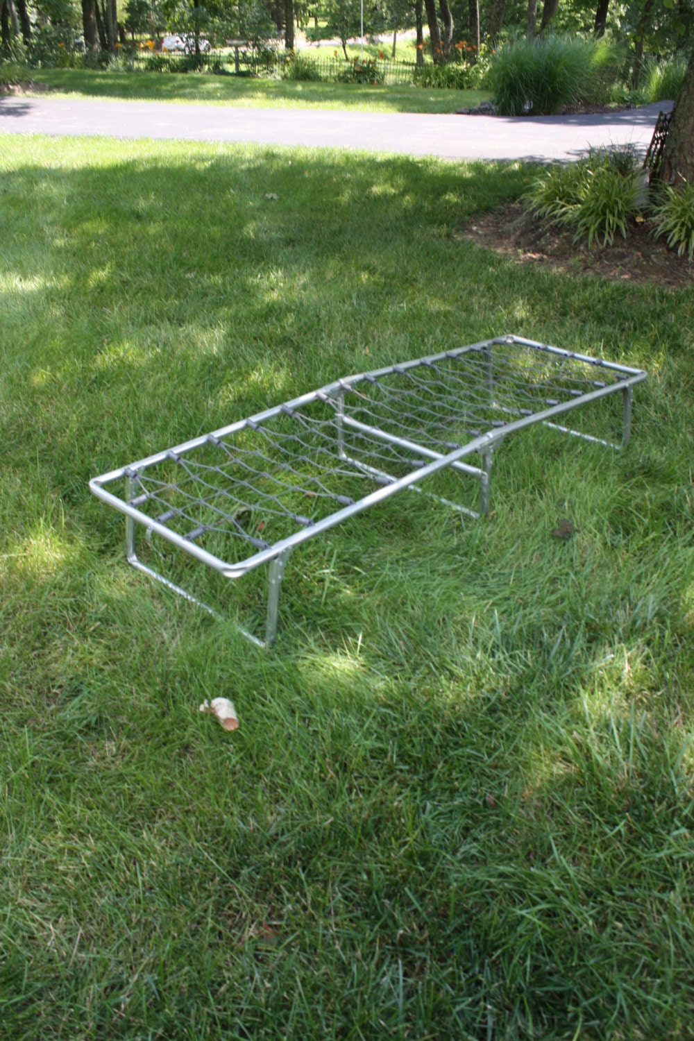 Fold down clearance cot for trailer