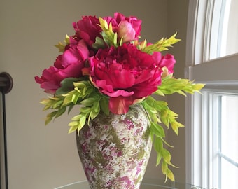 Fushia peonies with spring greens in colorful vase