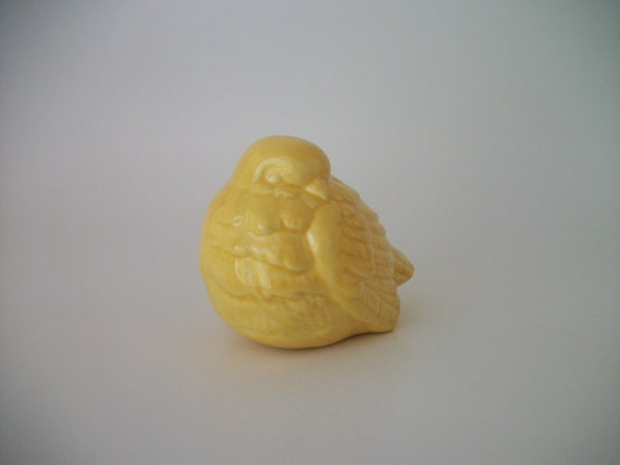 yellow ceramic bird figurine