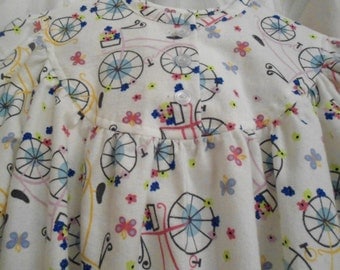Girls Size 7 Pajamas with yellow and lilac bycles on white.