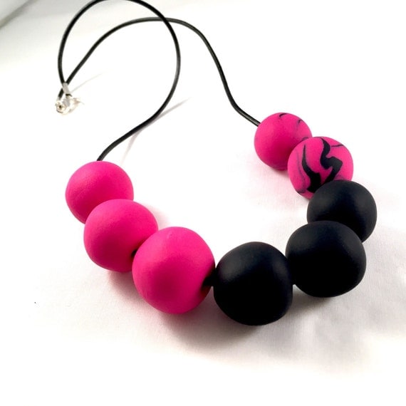 Bright pink and black necklace. Handcrafted polymer clay beads on a ...