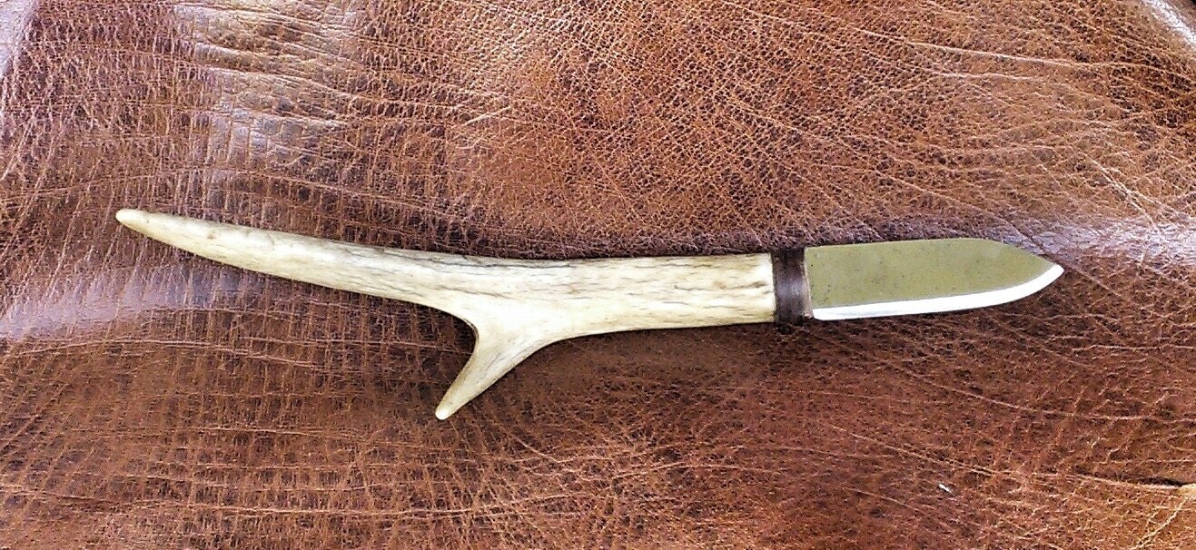 Hand deer antler knife with leather knuckle guard